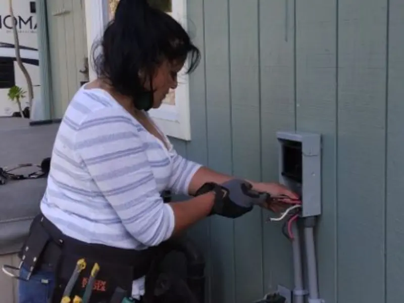 Licensed electrician wiring an exterior subpanel in Lake Monticello