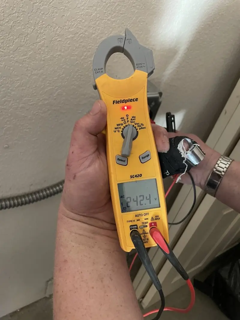 Voltage testing with clamp meter during Electrical Installation Services in Lake Monticello